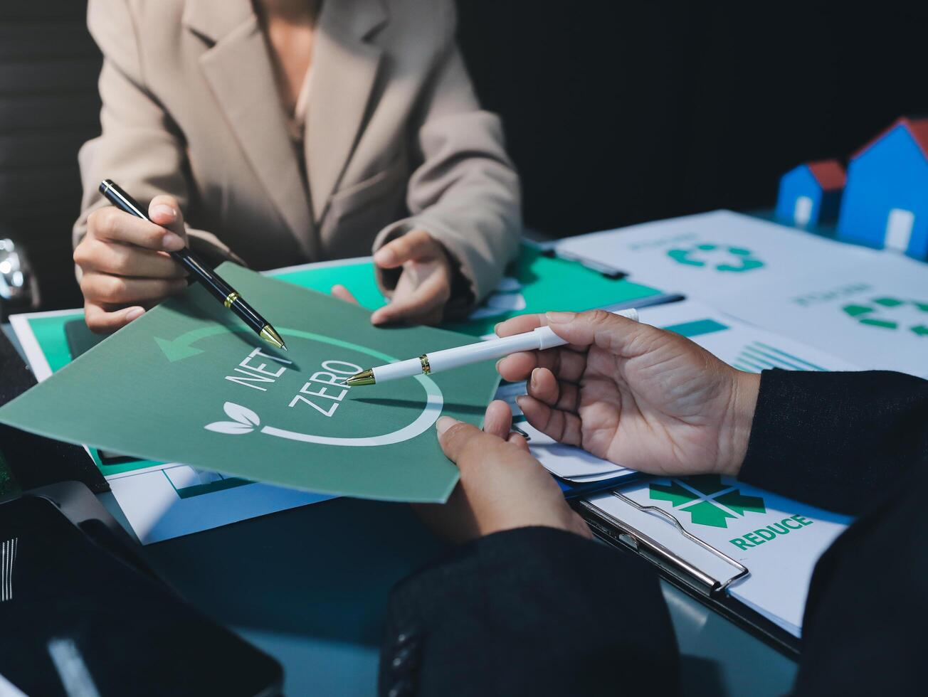 A man and woman are working on a paper with the words zerowaste photo