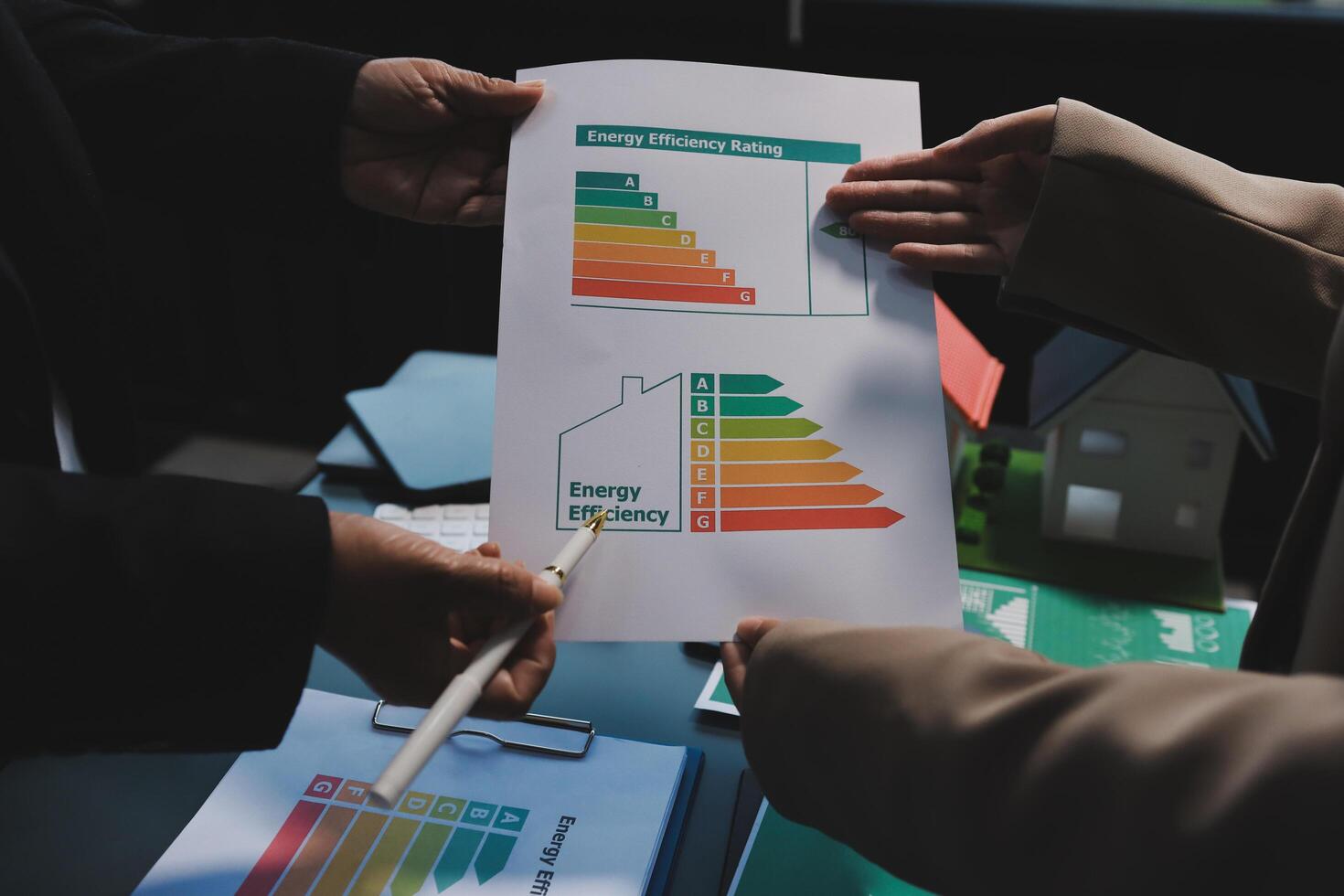 Two people holding a paper with an energy efficiency chart photo