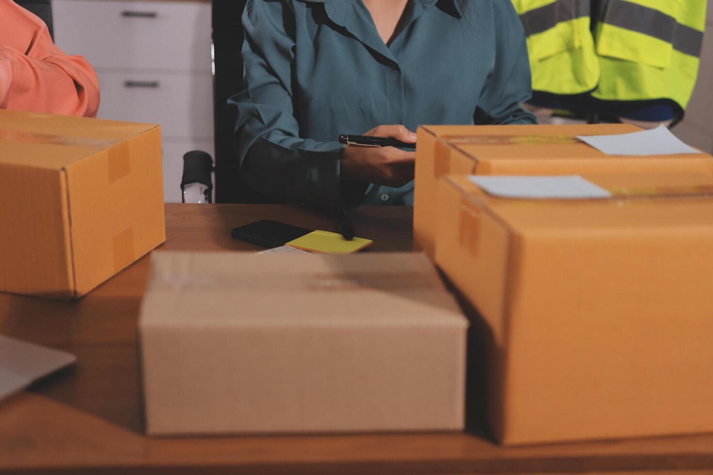 Two people are working on a computer and a box photo