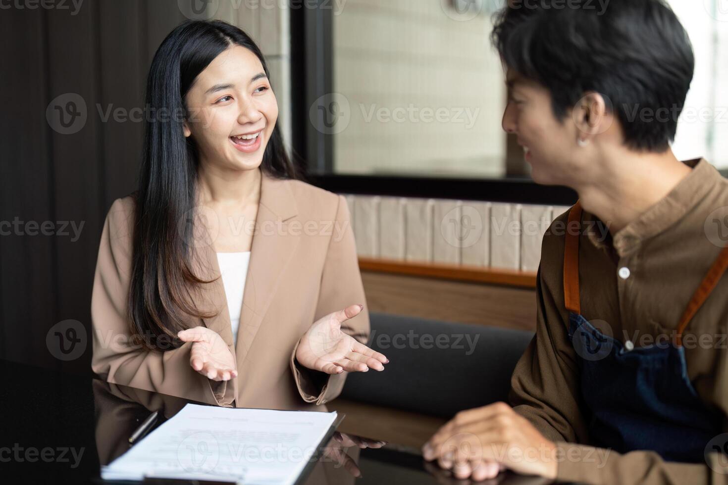 Entrepreneurial Discussion. Young professional explaining ideas in a cafe setting. photo