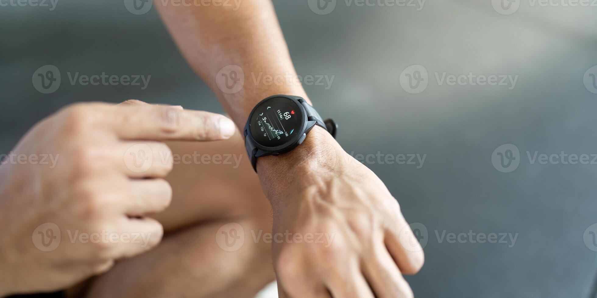 Smartwatch Usage. Man interacting with fitness watch after workout. photo