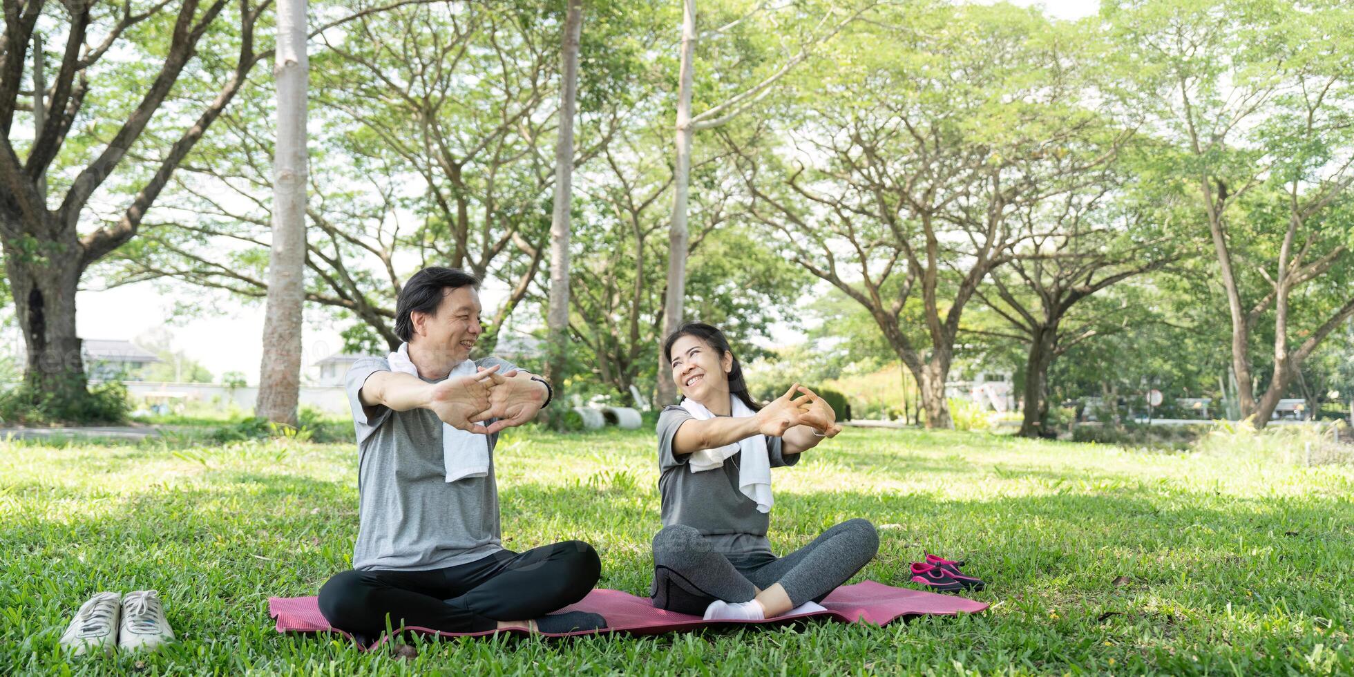 Couple Stretching Together in a Green Park. Embracing Wellness. photo