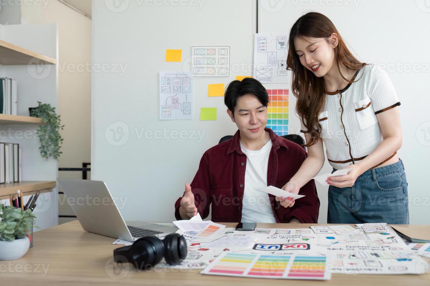 Creative Teamwork. Young designers discussing project ideas and sharing feedback in a modern office. photo