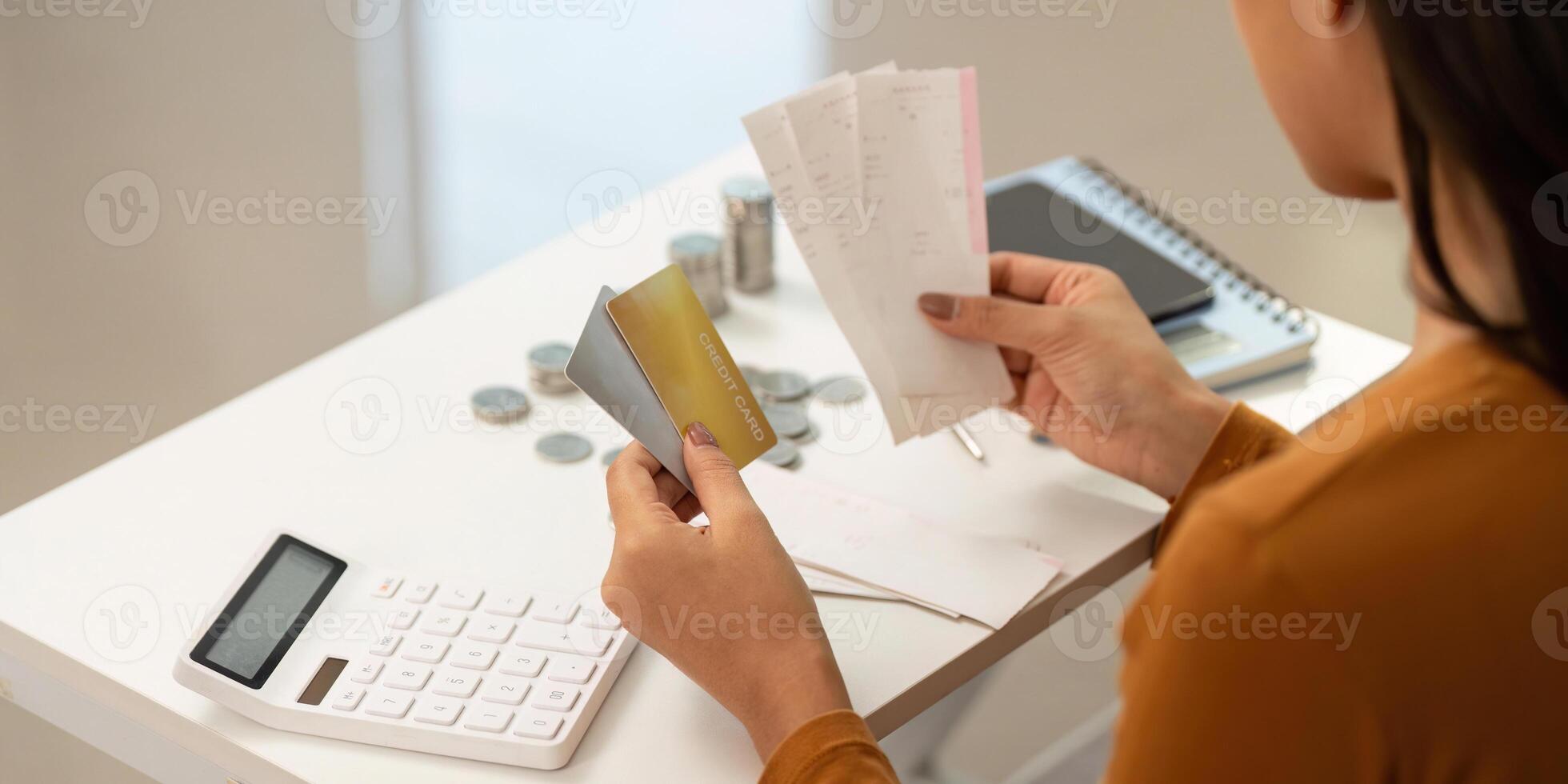 Financial Planning and Budgeting. Woman organizing expenses with credit card and receipts. photo