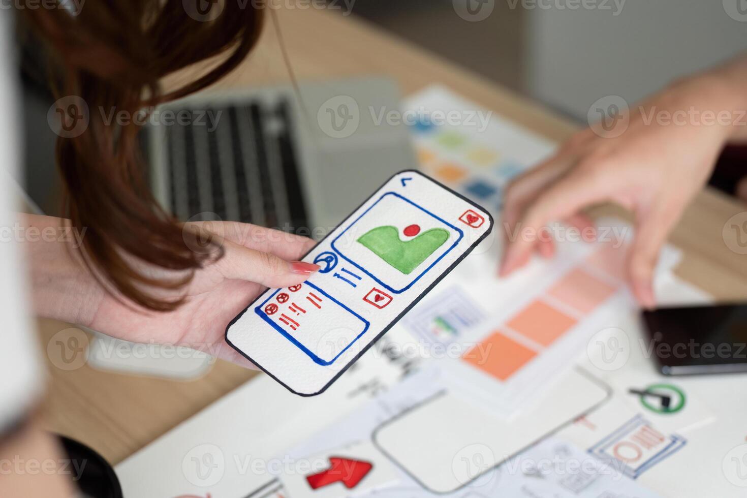 Mobile App Design. User interface mockup displayed on smartphone during collaborative session. photo