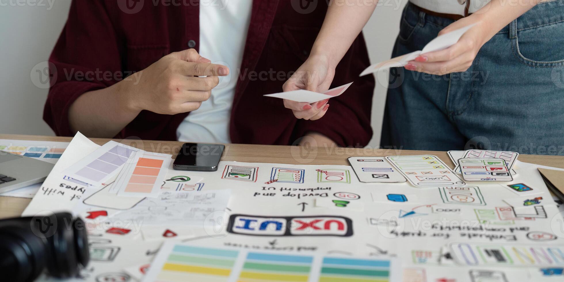 Design Collaboration. Young professionals sharing project ideas and materials in a creative workspace. photo