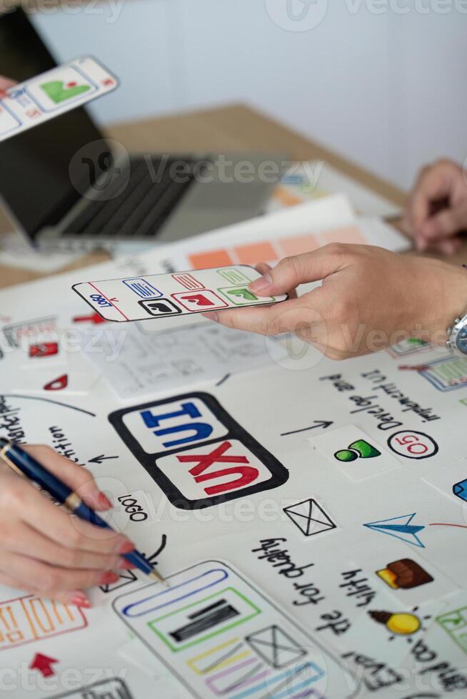 Collaborative UX UI Design Session. Team members sharing design ideas. photo