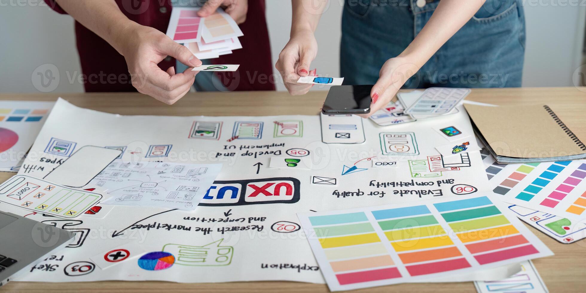 Collaborative Design Process. Two young professionals brainstorming and organizing ideas on a project. photo