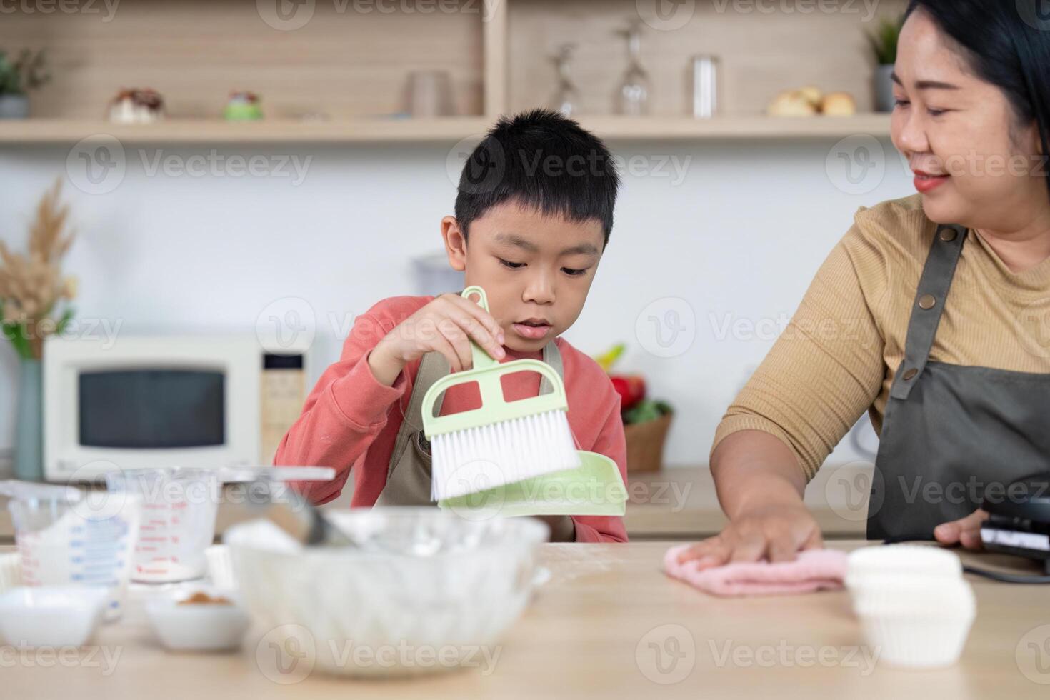 Cleaning and Learning. A child focused on cleaning with guidance from an adult. photo