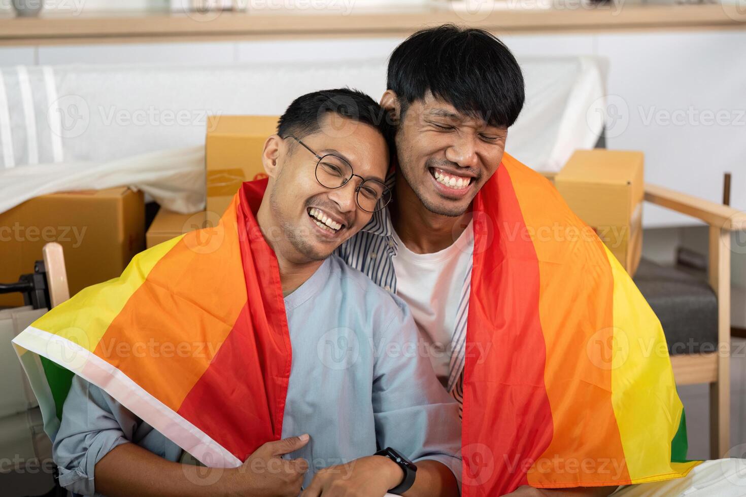 LGBT couple celebrating love with pride flags in their new home photo