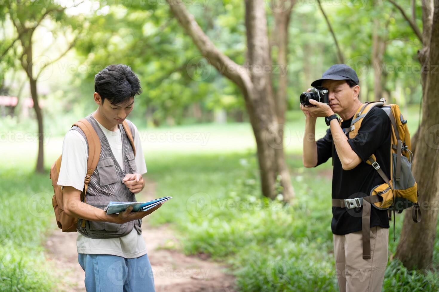 Father and Son Capturing Memories. Hiking with a camera and map. photo