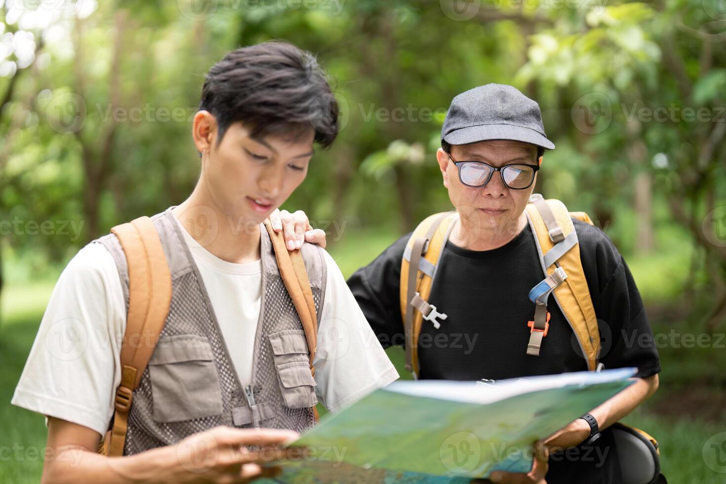 Father and Son Hiking Adventure. Exploring nature together with a map. photo