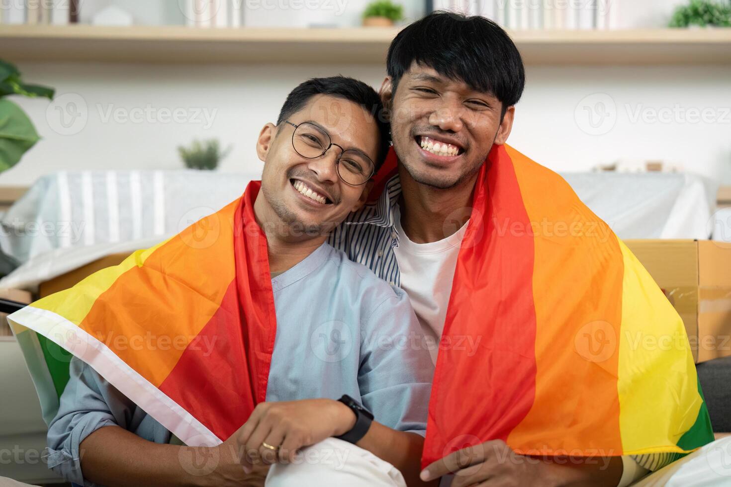 Affectionate gay couple wrapped in pride flags, celebrating love photo
