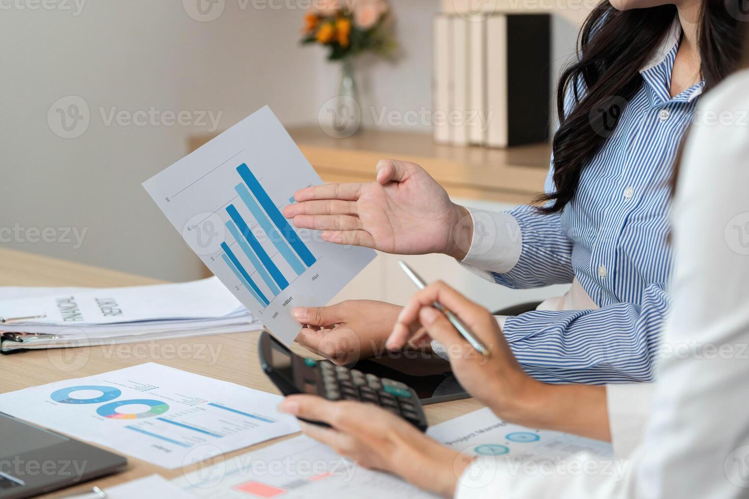 Data Presentation and Financial Insights. Professionals discussing financial graphs and reports. photo