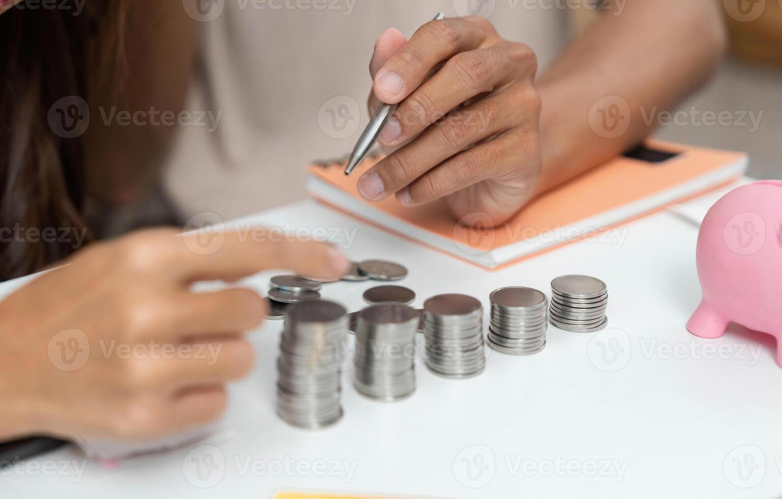 Counting Coins for Financial Management. Close-up of couple organizing coins and savings. photo