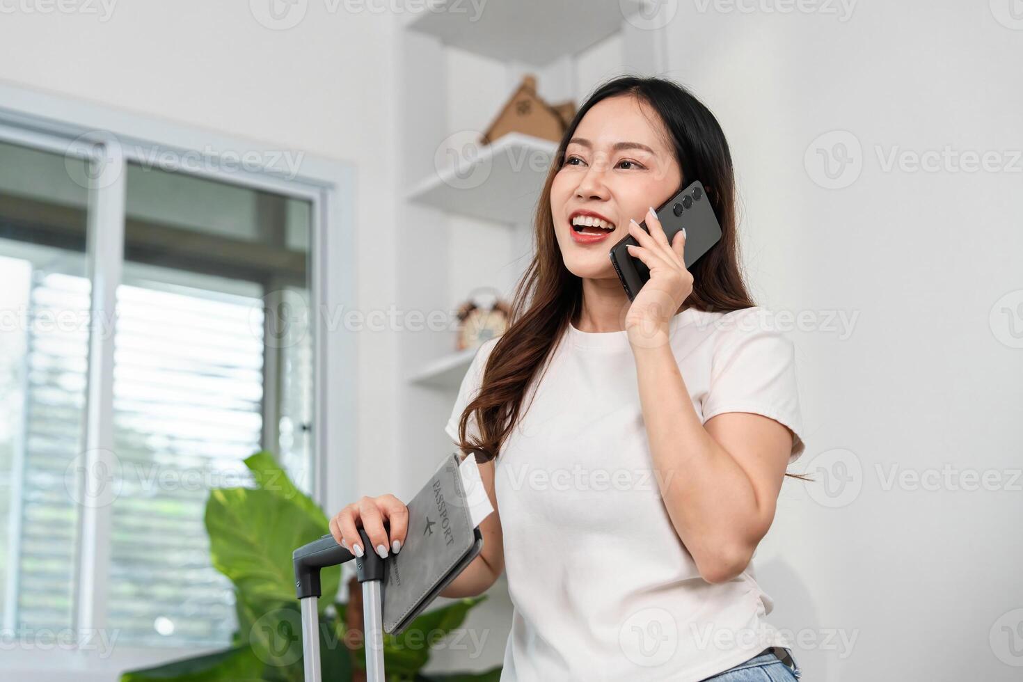 Travel Enthusiast on Call. Woman excitedly planning her journey with smartphone. photo