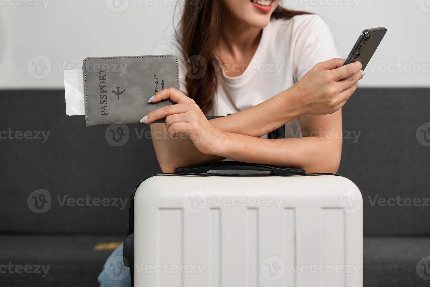 Travel Ready with Passport and Smartphone. Woman preparing for her next journey. photo