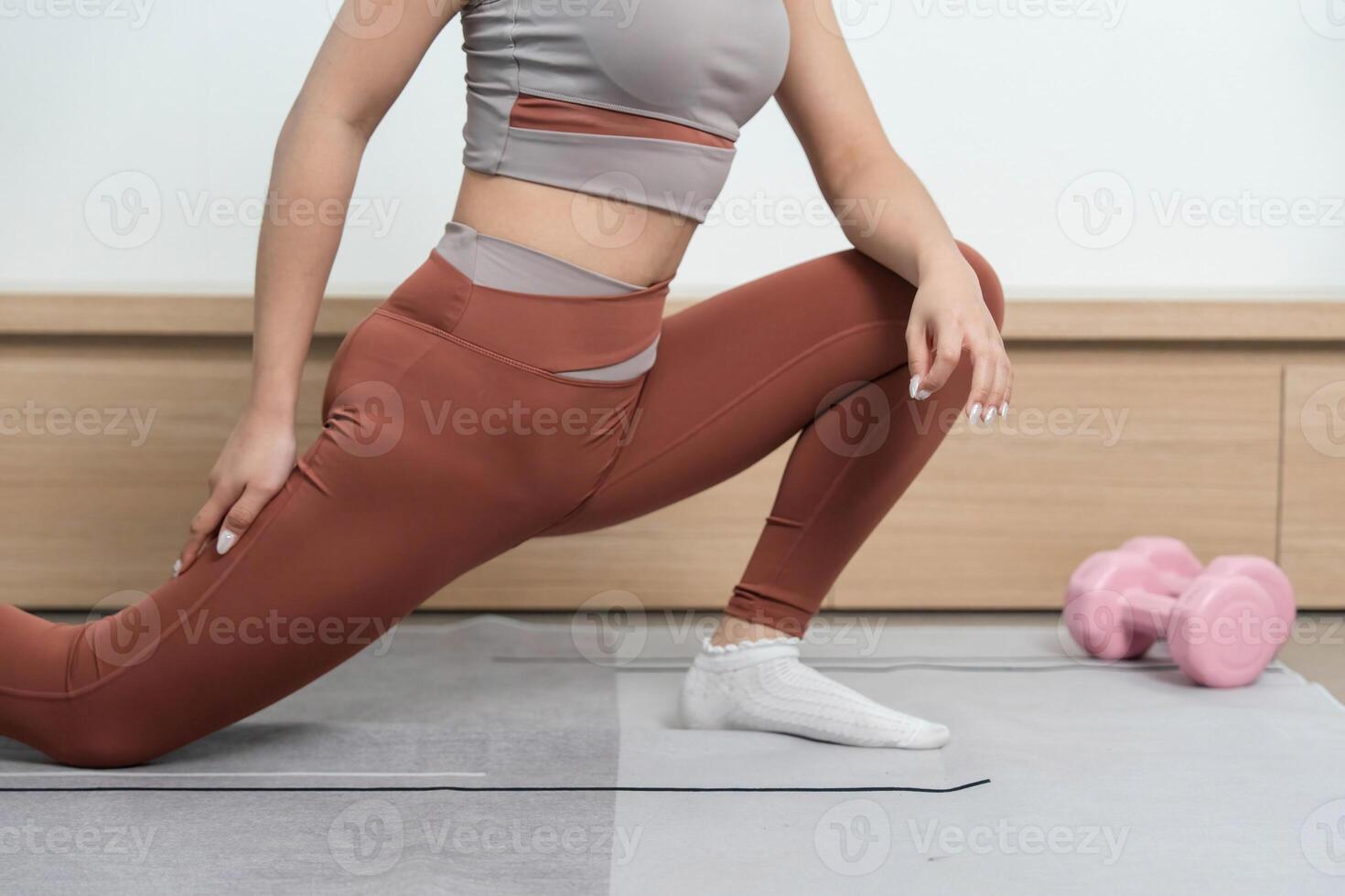Yoga and Fitness. Close-up of a woman in a lunge stretch, focusing on form and posture. photo