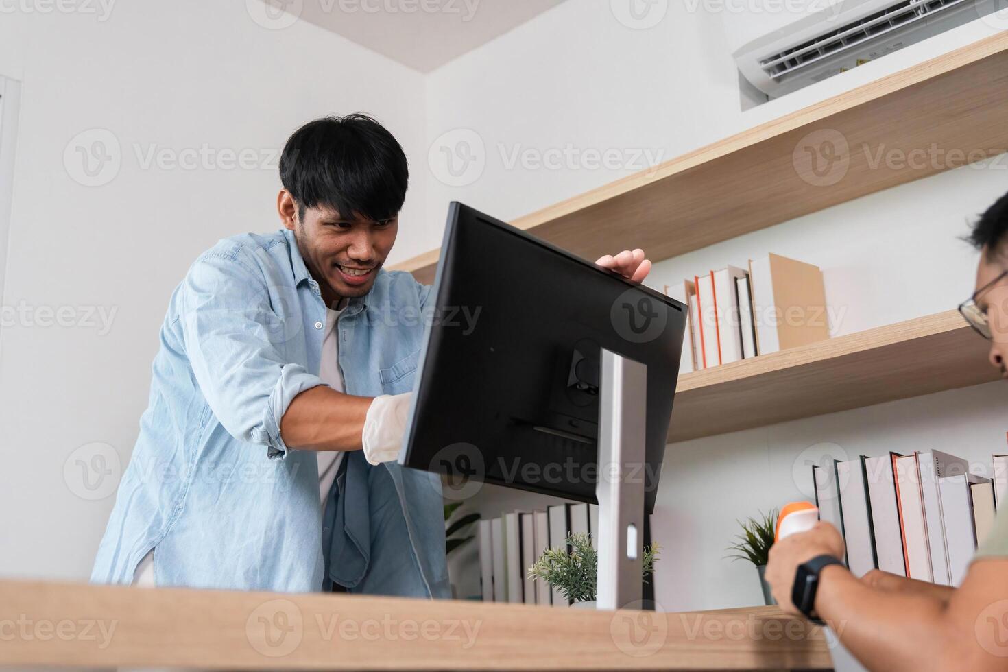 Office Maintenance and Support. A technician assisting with computer setup in a modern workspace. photo
