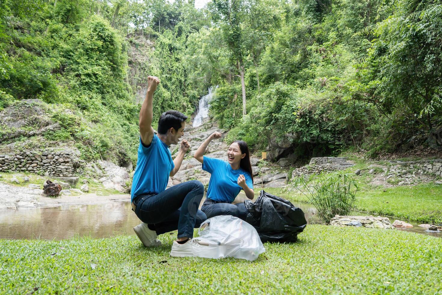 Celebrating Volunteer Success. Two volunteers cheer after successfully collecting waste during a community cleanup. photo