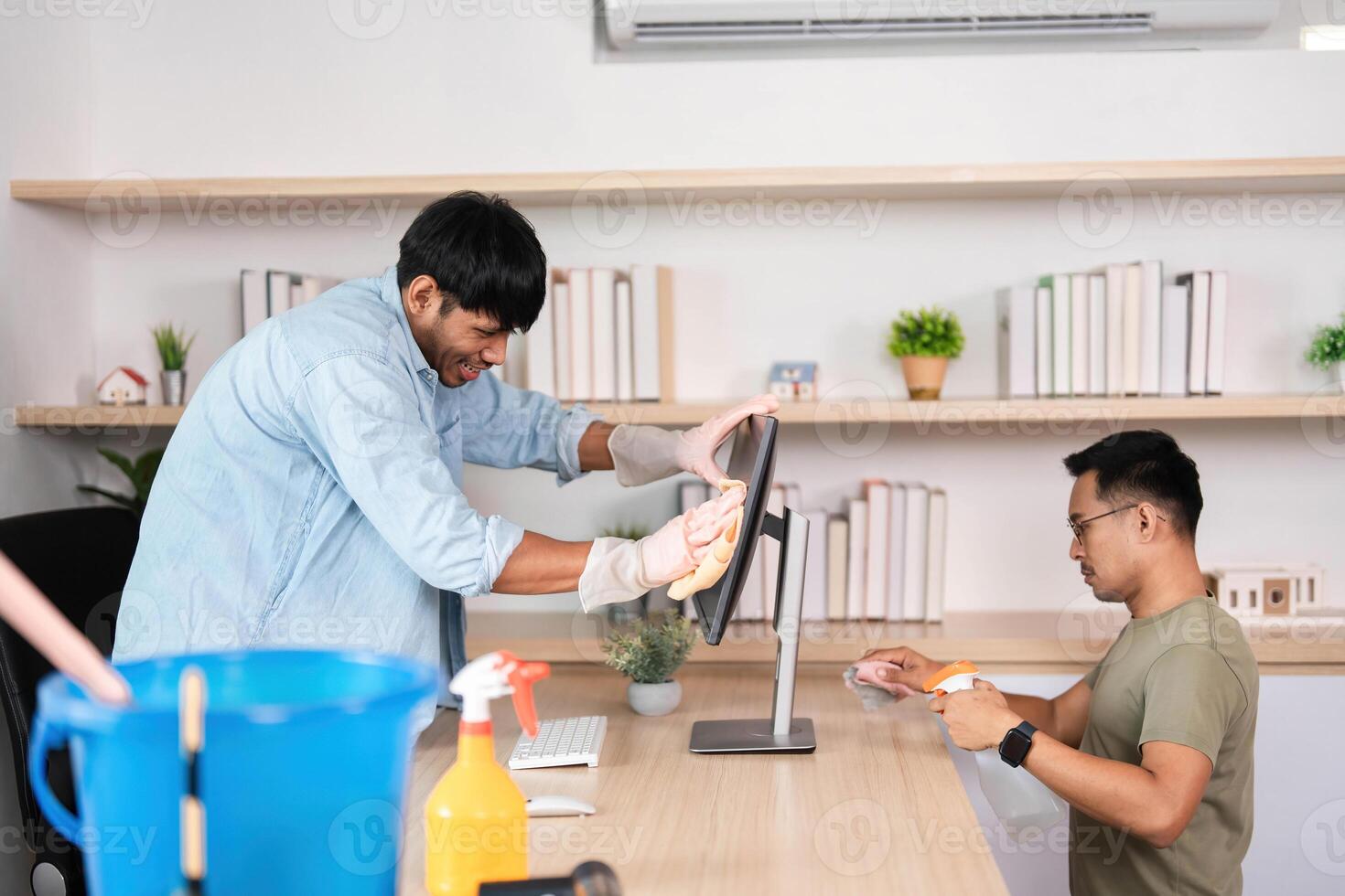 Teamwork in Office Cleaning. Two men collaborating on workspace maintenance. photo
