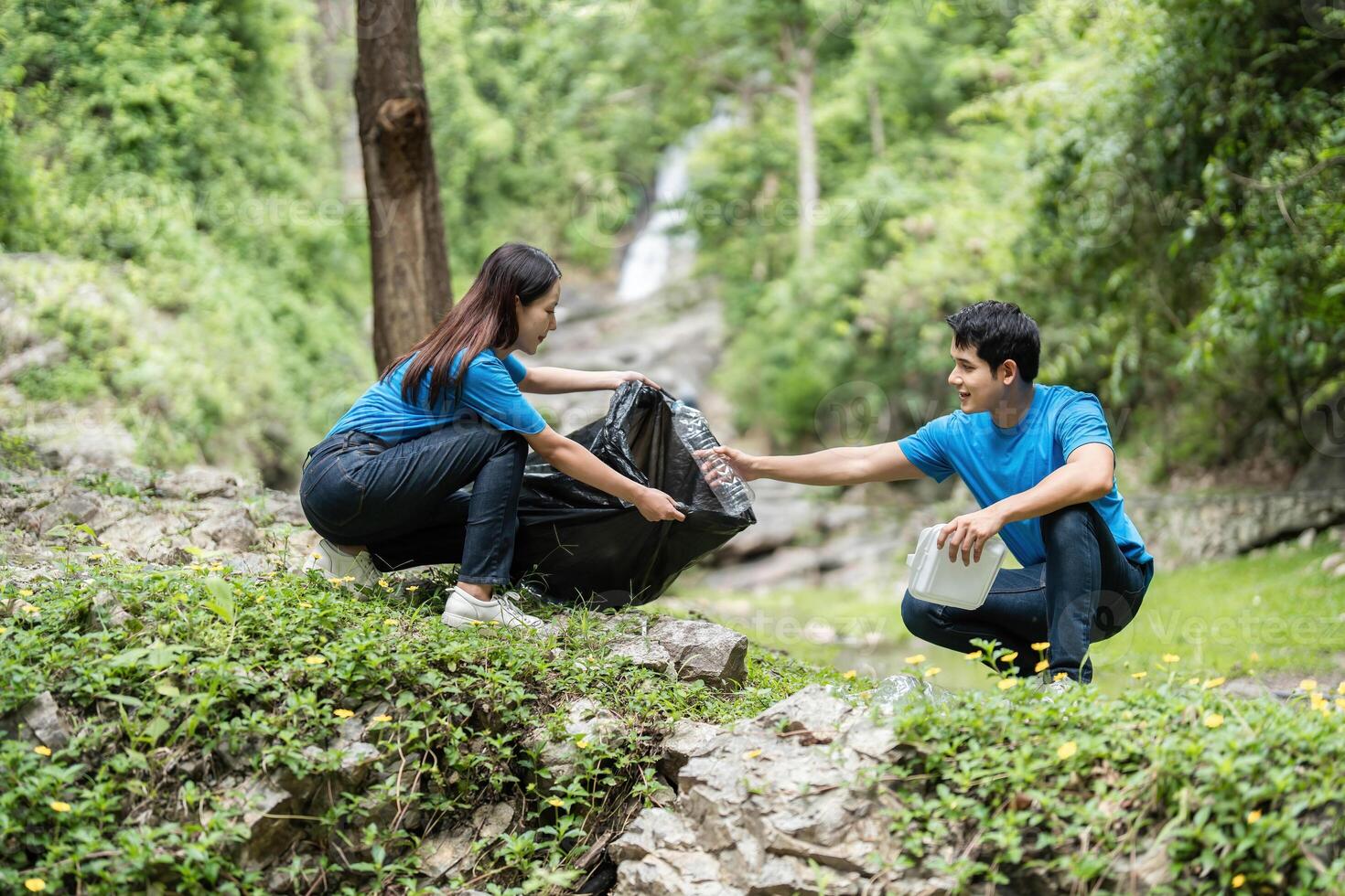 Volunteer Team Collecting Waste in Nature. Two individuals collaborating to clean up a beautiful landscape. photo