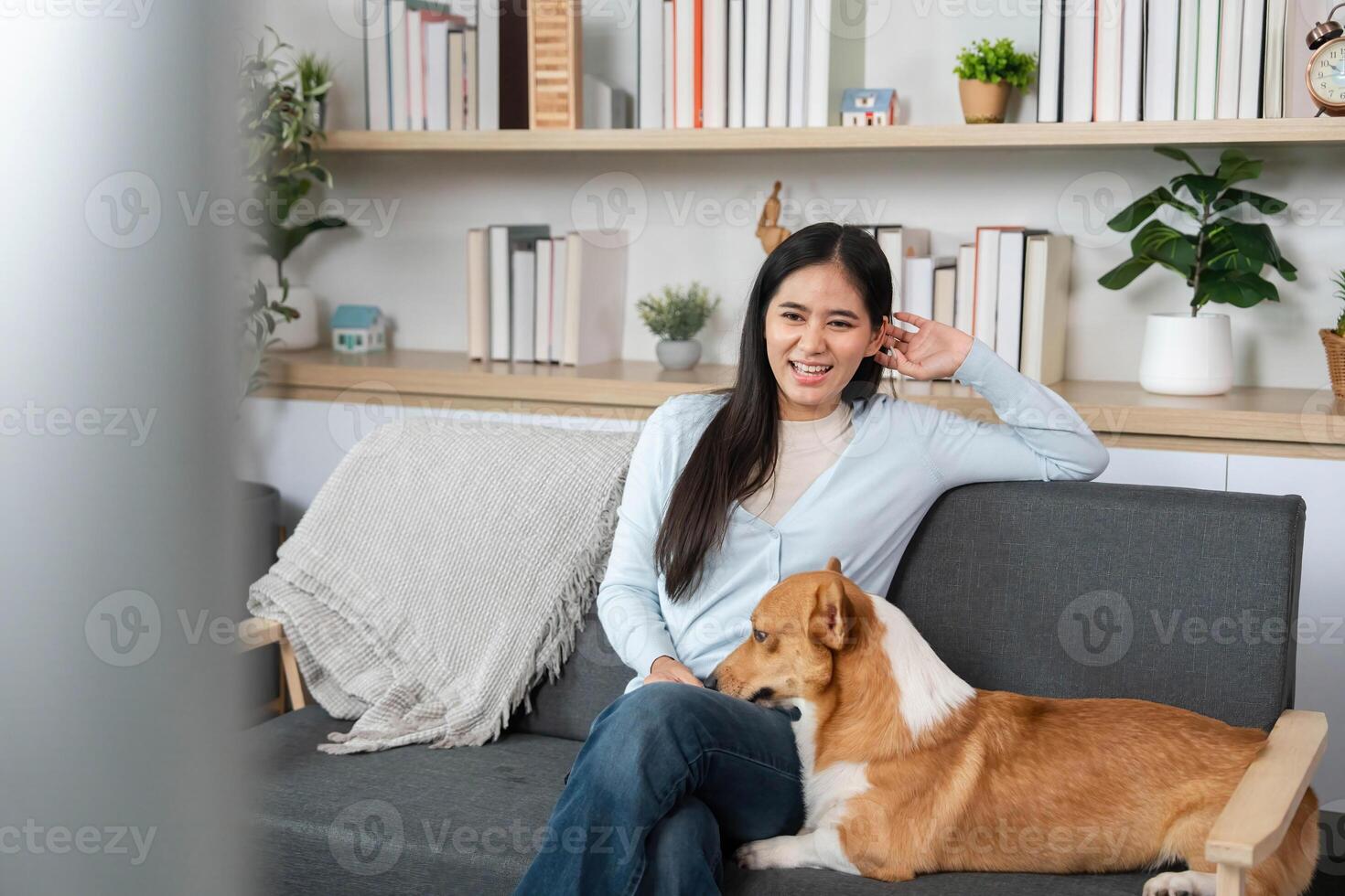 Comfort and Connection with Pets. Young woman relaxing with her dog while watching TV. photo