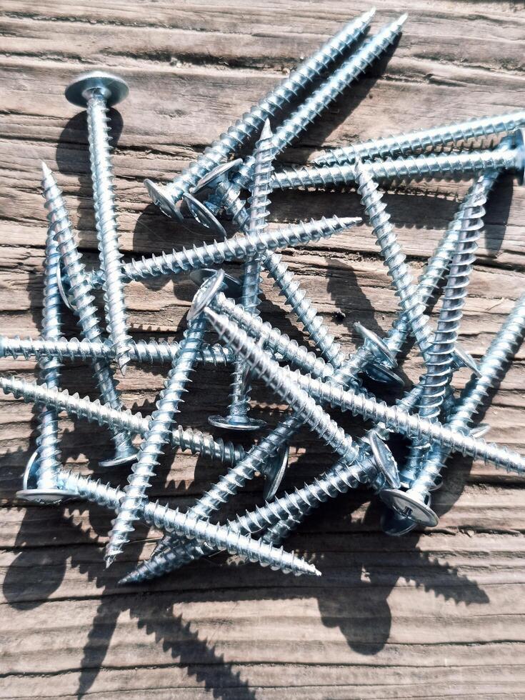 Long screws lie on the board photo