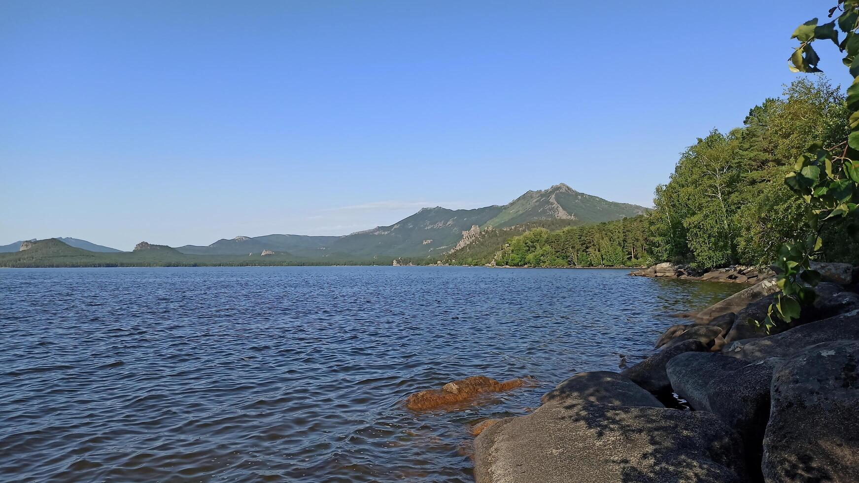 View of the lake and mountains at the Borovoe Burabay resort in Kazakhstan photo