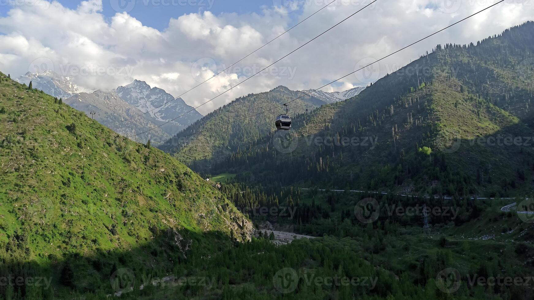 Mountains in Almaty. In the distance you can see the cable car that leads to the Shymbulak ski resort photo