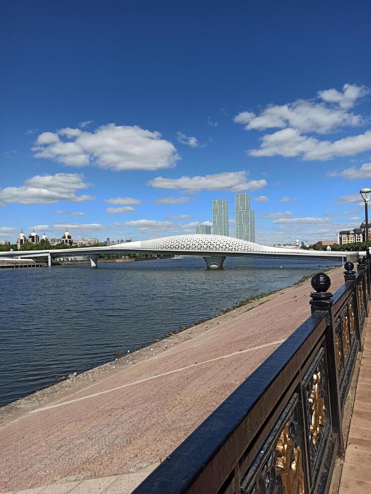 Astana, Kazakhstan 08.15.2022, Attraction Atyrau Bridge passing through the Ishim River, promenade photo