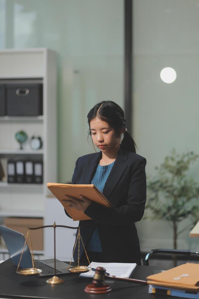 A woman in a business suit is standing at a desk with a clipboard photo