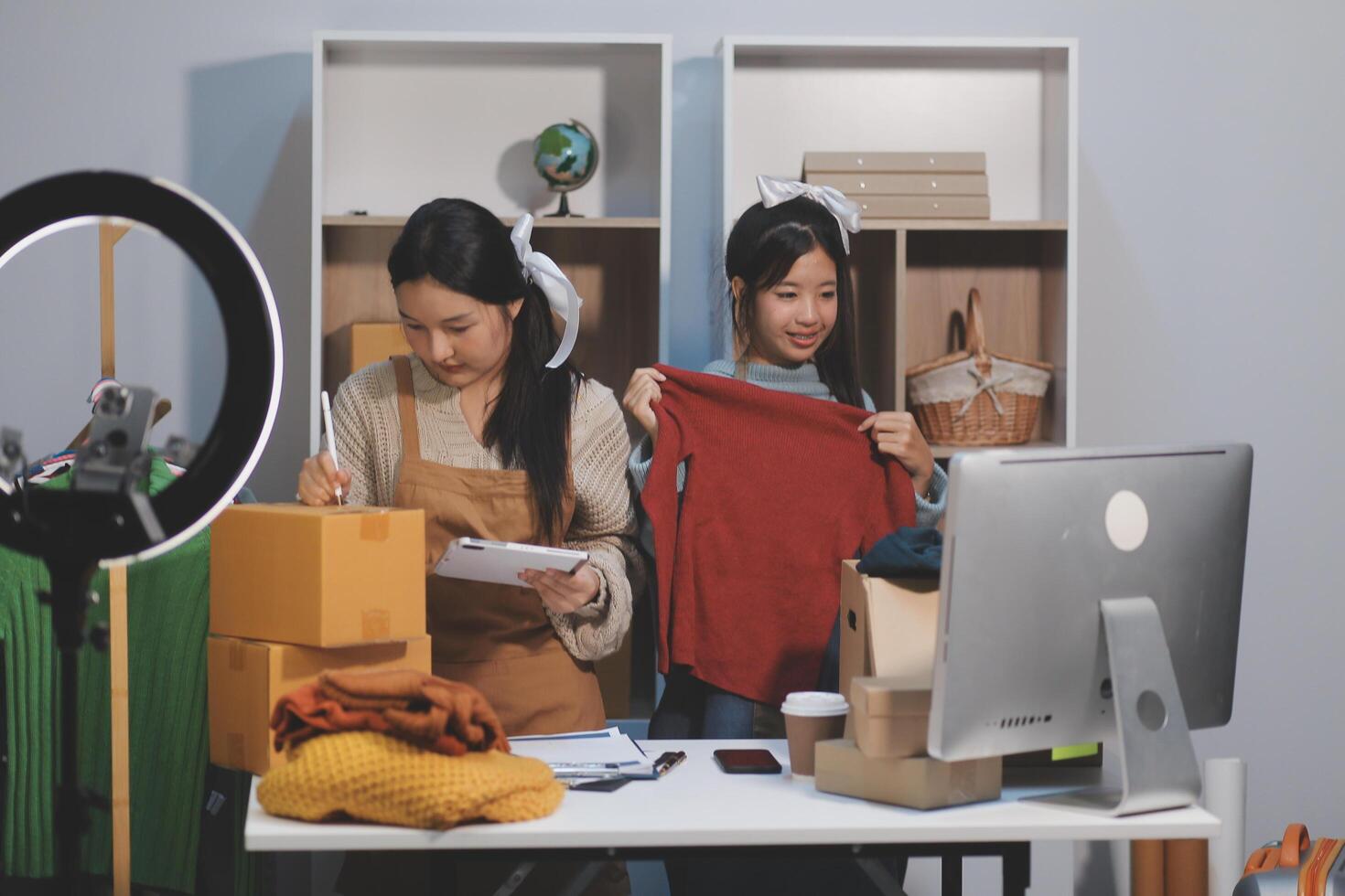 Two women are working on a computer and a camera photo