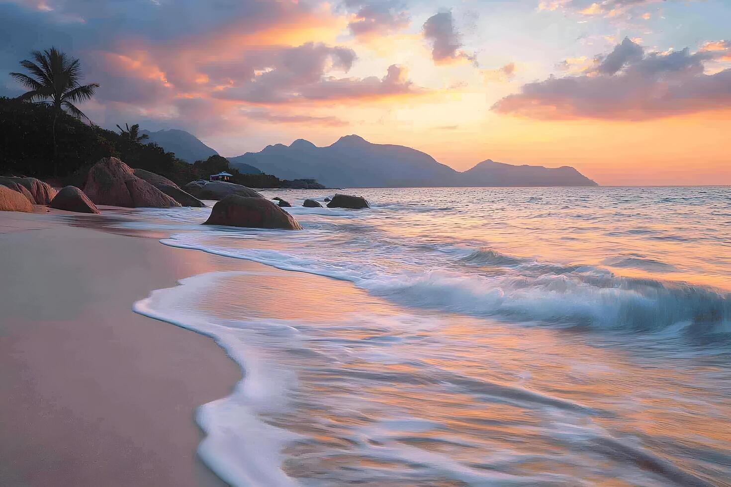 Serene sunset beach scene tropical ocean waves gently lapping sandy shore palm trees rocky shoreline mountains backdrop photo
