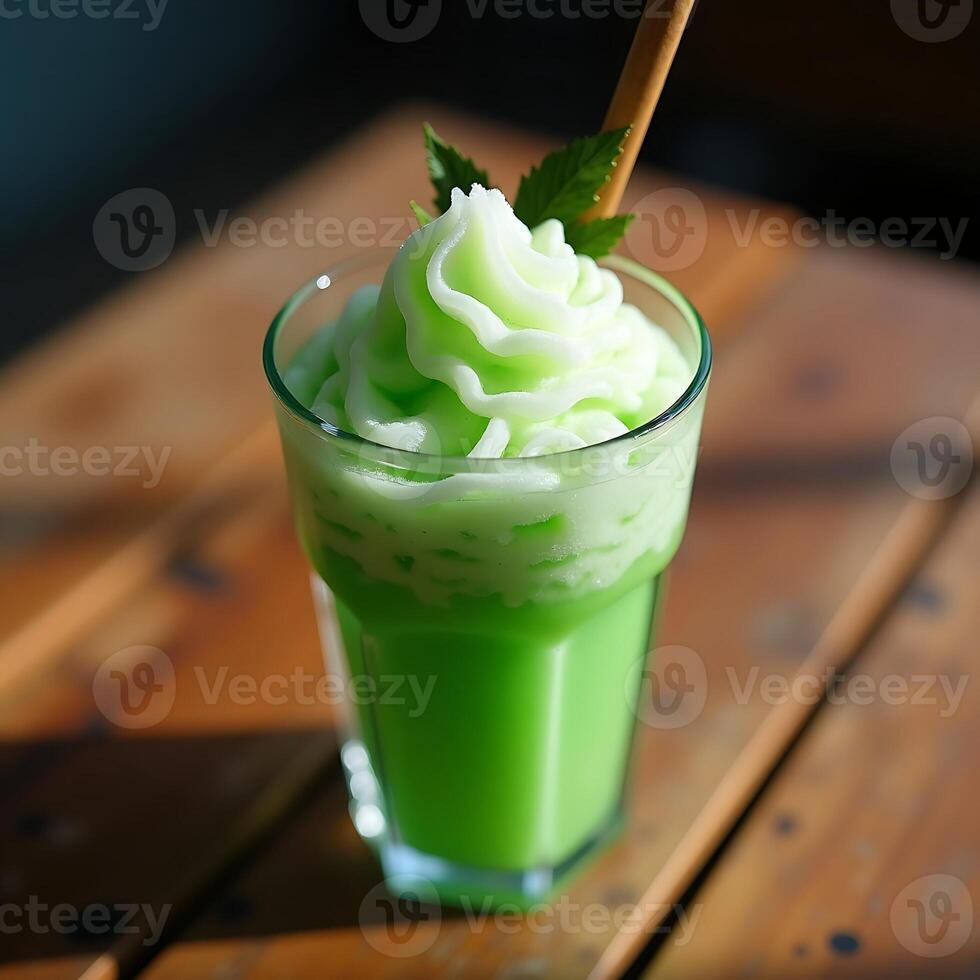 Refreshing Green Smoothie with Whipped Topping and Straw photo