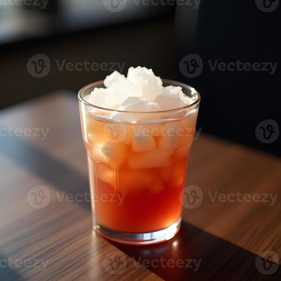 Refreshing Drink with Ice in Glass on Wooden Table photo