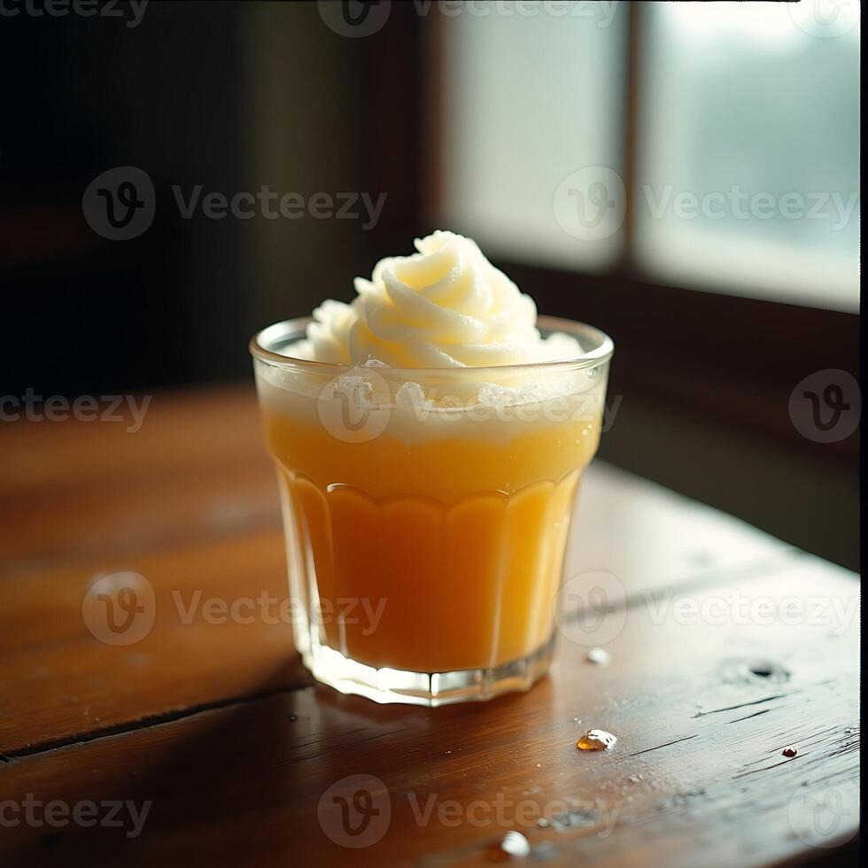 Refreshing Orange Juice with Creamy Topping in a Glass photo