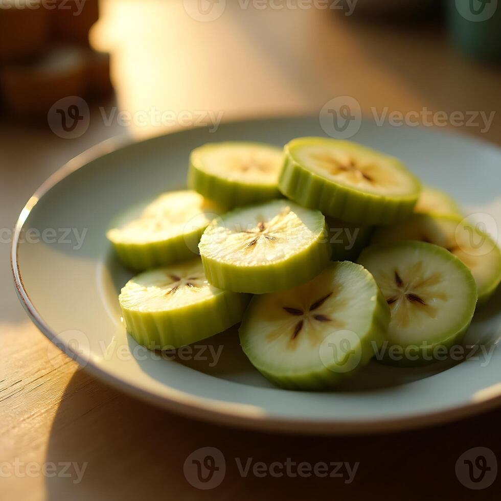 Sliced Fruit on Plate Illuminated by Warm Light photo
