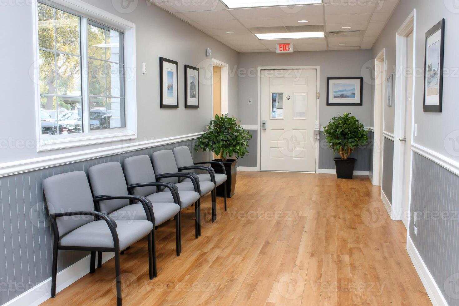Empty waiting room with gray chairs and wooden floor photo