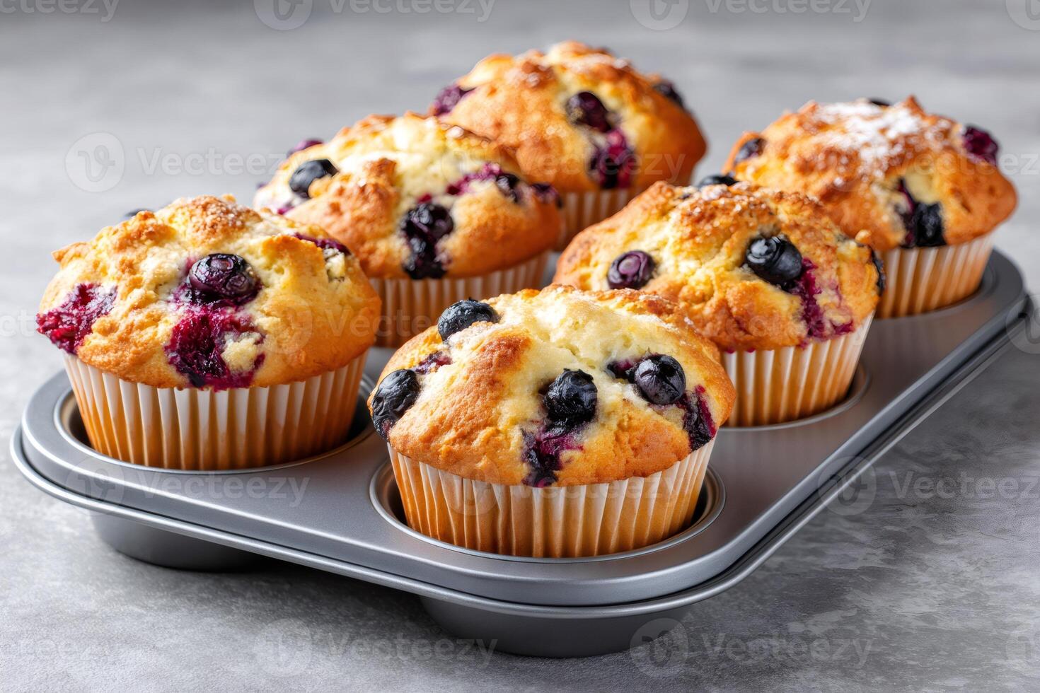 Delicious blueberry muffins baking in a muffin tin photo