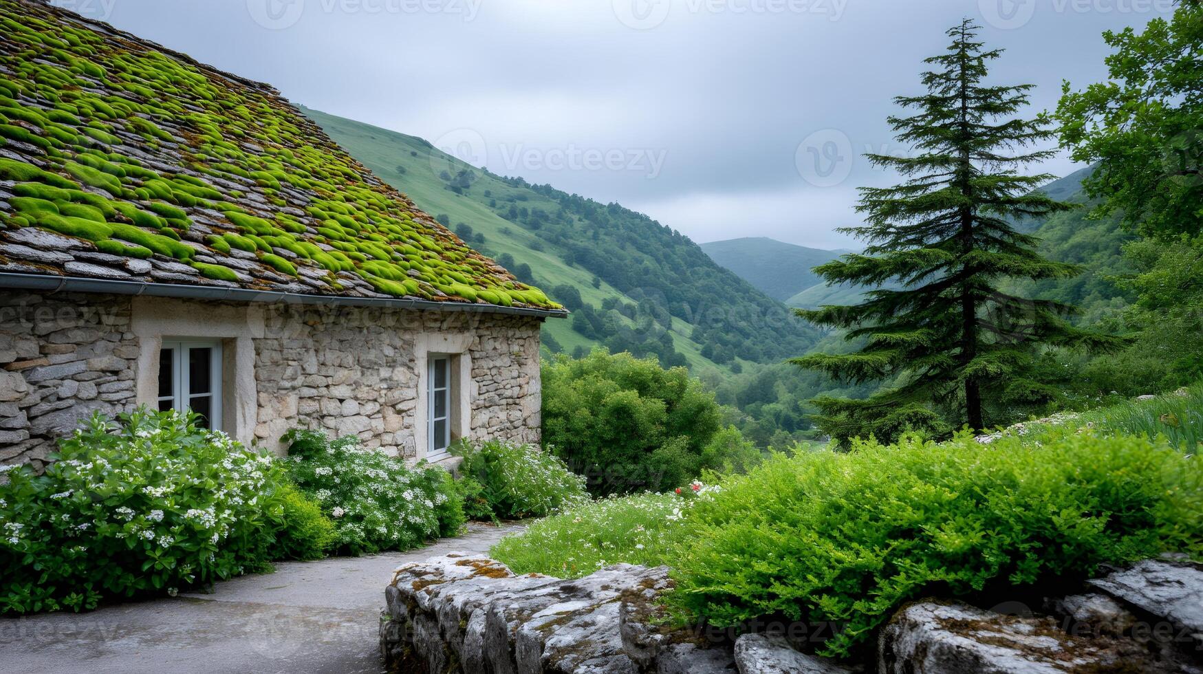 Old stone house with moss covered roof in green mountain valley photo
