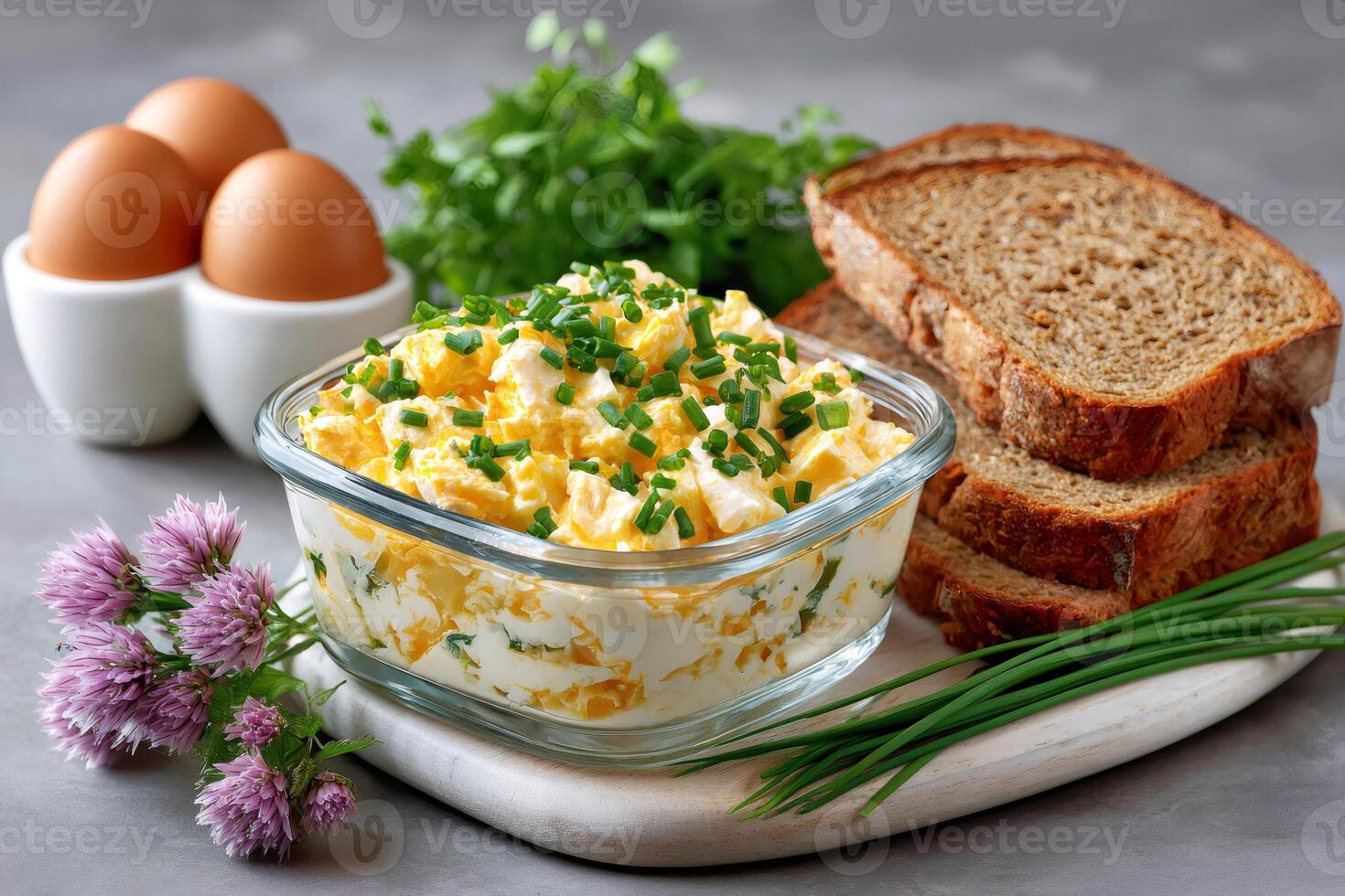 Egg salad with chives and herbs served with whole wheat bread photo