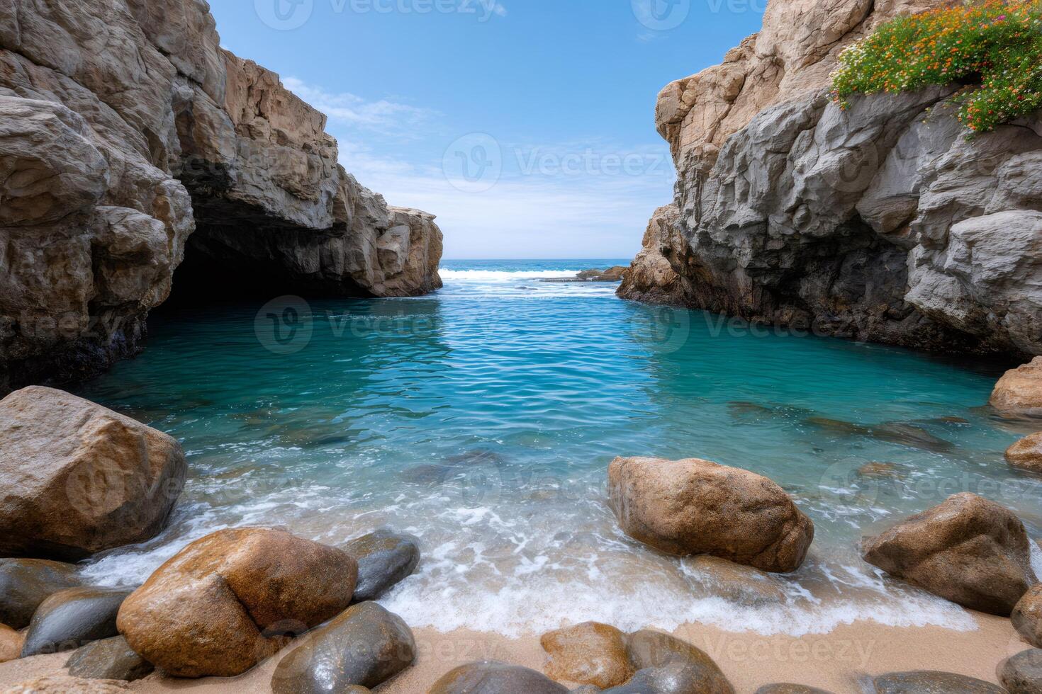 Turquoise water flowing into a rocky cove on a sunny day photo