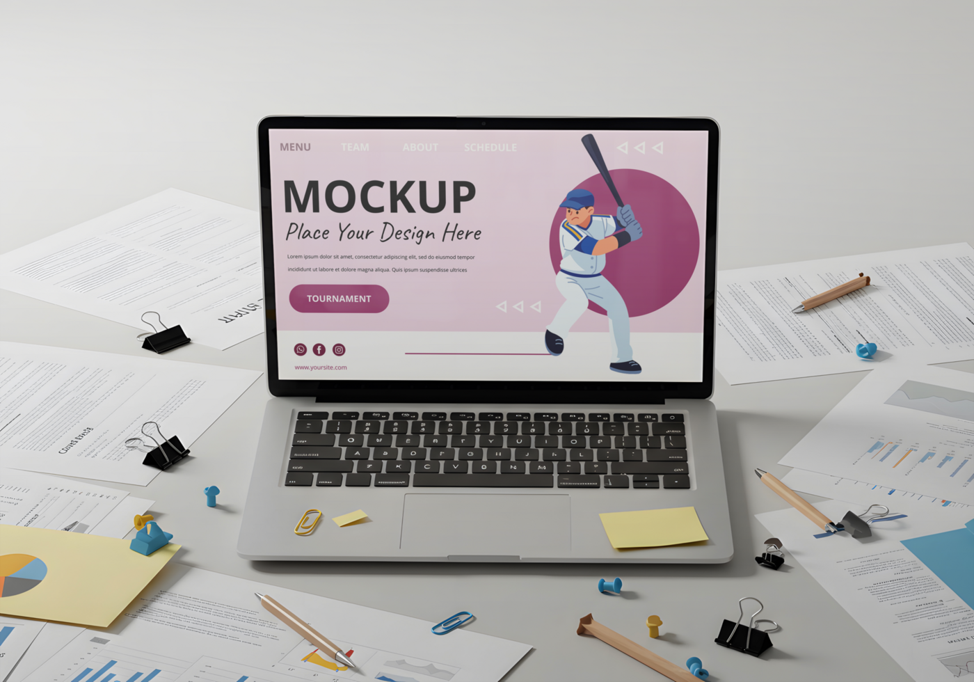 A laptop displaying a baseball player graphic sits amidst paperwork on a desk psd