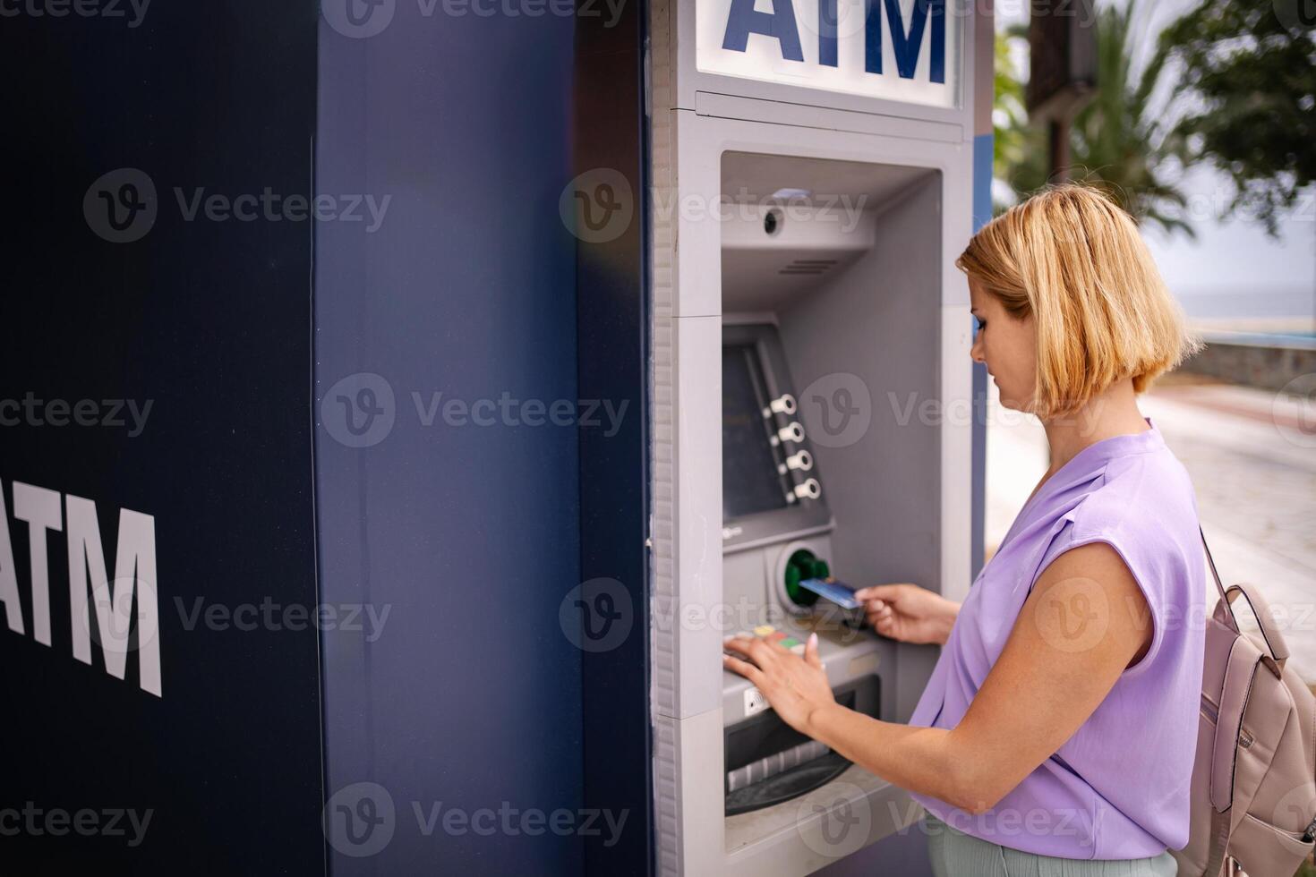 Summer banking at an ATM in beautiful Greece photo