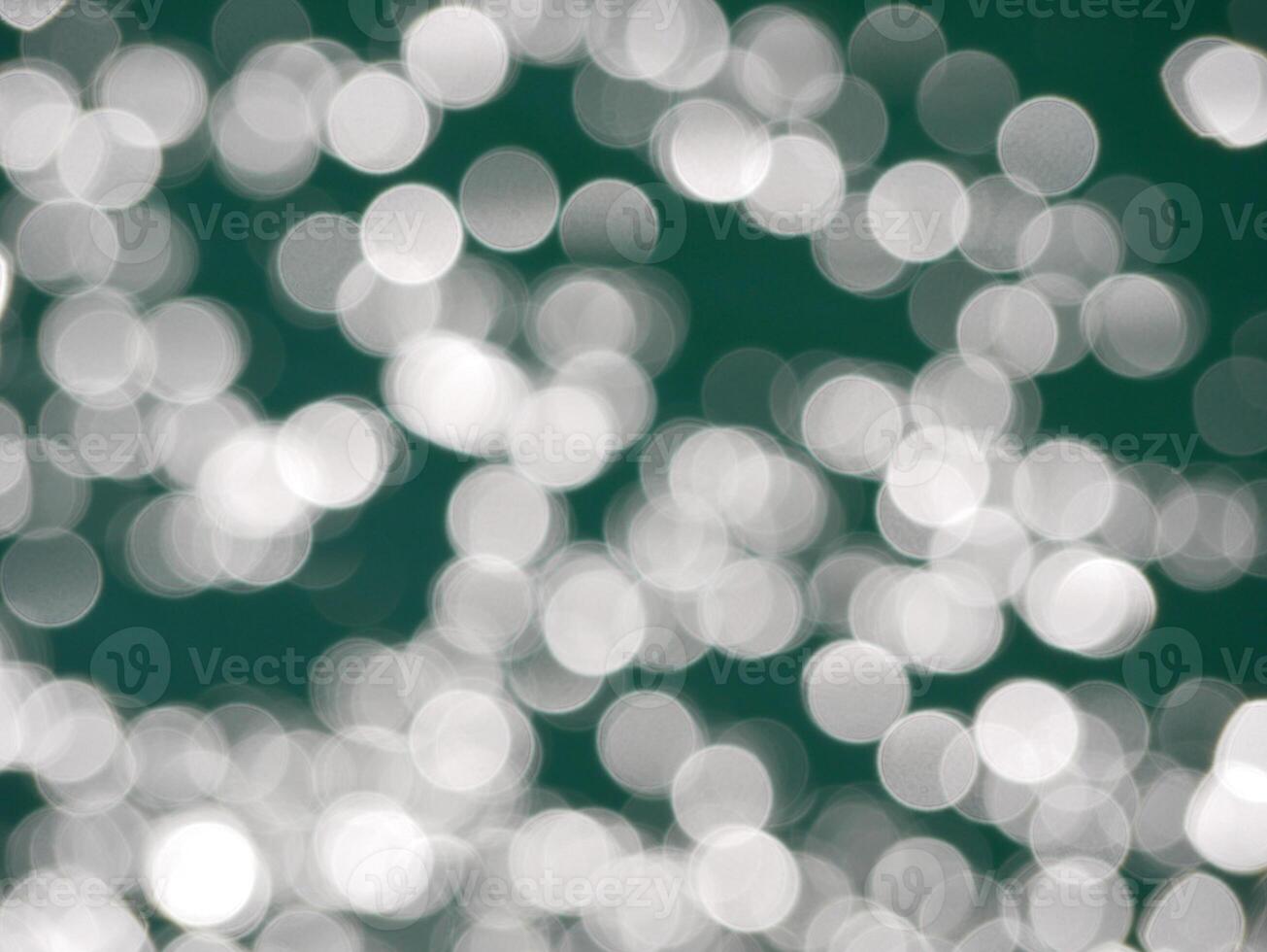 Water surface top view. Blurred defocus with bokeh effect. Sun glare on water. Background abstracted texture wallpaper photo