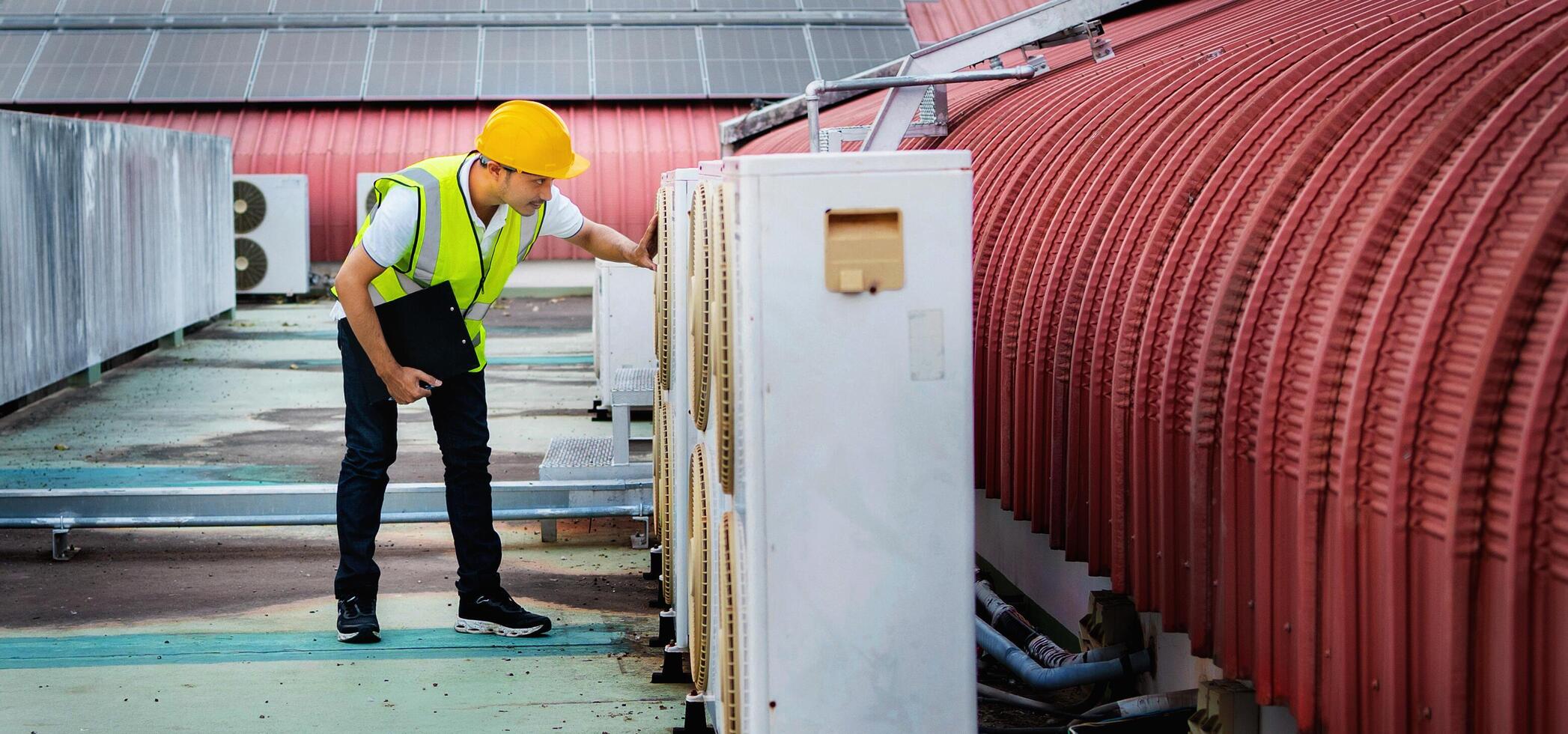 man in a yellow vest is inspecting a building photo