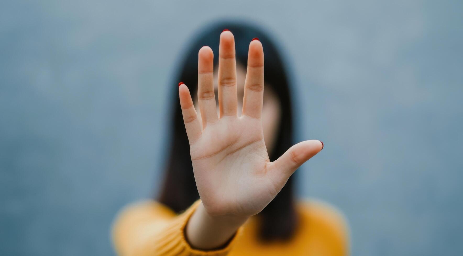 Woman's Hand Showing Stop Gesture A Powerful Symbol of Rejection, Defense, and Boundaries photo