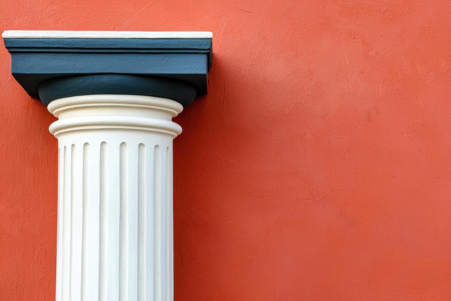 Classical Column against a Red Wall Architectural Detail and Geometric Design. A study in contrast and texture, showcasing the ele photo
