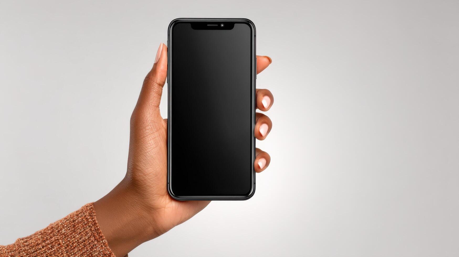 of a hand holding a black smartphone with a blank screen. The image showcases modern technology and mobile communication in a simp photo